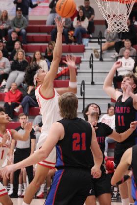 Dale junior Keldan Meely picks up a rebound and adds two to the board during the Dec. 13 game against Oklahoma Christian School (OCS) in the Dale Boomarang Basketball Classic. The Pirates won all three of their games in the three-day tournament - OCS, 80-37; Kingfisher, 65-46; and OCS, 82-69 - and placed first.