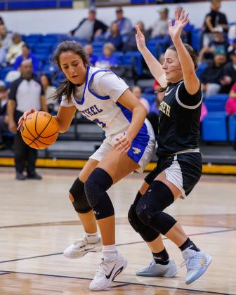 Bethel senior Alexis Tucker maneuvers around Tecumseh senior Cadence Leba during the Dec. 11 game in the Bethel First United Basketball Classic. The Lady Wildcats won this game, 49-36; beat Pauls Valley, 42-39; then fell to McLoud, 41-63, to take second in the three-day tournament. Photo courtesy of Richelle Treece.