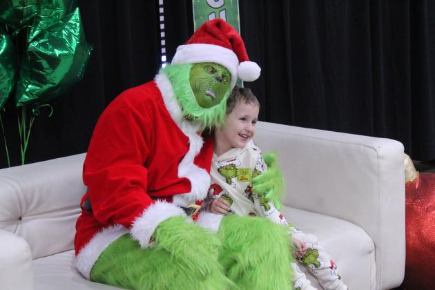 James Bowles, 3, of Maud, gets a hug from the Grinch in the City of Tecumseh Chambers during the Grinchmas/Whoville event on Dec. 11. Bowles has had his picture with the Grinch since he was 9 months old, according to his mother. Tecumseh Public Library/Pioneer Library System staff took and printed pictures with the Grinch, as they have in past years.