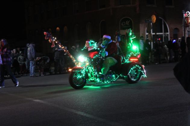 The Grinch rides a motorcycle in the Grinchmas Parade in Tecumseh on Dec. 11. He was part of the BancFirst entry, which won third place. Tecumseh Chamber of Commerce Executive Director Kim Elliott said there were 65 entries in the parade this year. The City of Tecumseh won first, and Ollie's won second.