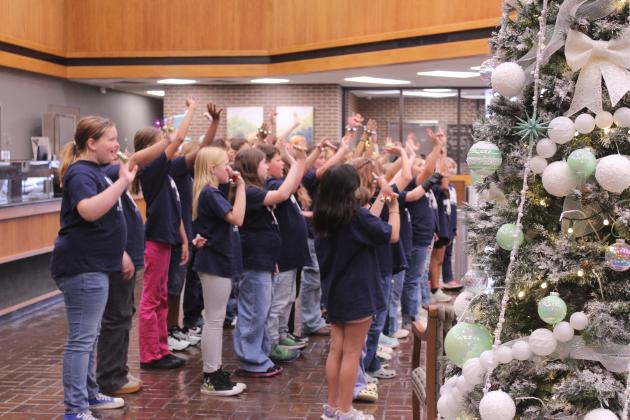 Will Rogers Elementary Choir members sing "Holly Jolly Christmas" during the Salvation Army Angel Tree Kickoff event at Sovereign Bank in Shawnee on Nov. 20. Co-Captains Leanna and Thomas Marion, and Women's Auxiliary Angel Tree Coordinator Robbie Foxx spoke during the event.