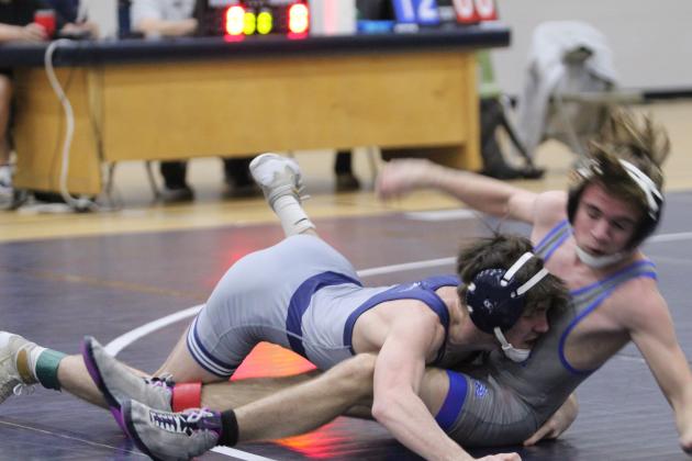 In the 120 weight class, Shawnee's Blayne Taber rushes his Newcastle opponent during the Shawnee High School Boys Dual on Dec. 2. The Wolves won the meet, 46-36.