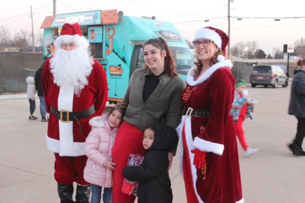 Santa and Mrs. Claus pose with Kourtney Jones, Evaleya Jack, 5, and Zakai Black, 3, during the Fourth Annual Shawnee Police Department Toy Drive on Dec. 18. Public Information Officer Corporal Vivian Lozano-Stafford said they had 200 children who registered online and lots of sponsors who made the event possible, including Travelin' Tom's Coffee, who was giving away hot chocolate.