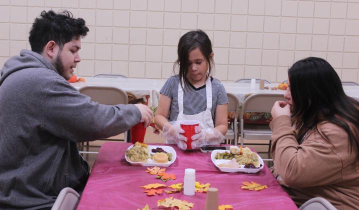 Madisyn Castaneda, 10, serves drinks to Jimmy and Unity Alas of Maud during the 20th Anniversary Tecumseh Family Thanksgiving Dinner, held at the Tecumseh City Hall Auditorium on Nov. 27. U. Alas said she used to come to the dinner with her father and grandmother, and decided to introduce her husband to it this year. Castaneda was volunteering for the first time with her two sisters and her parents, Daniel and Amber Castaneda. Natasha Dunagan, Countywide &amp; Sun