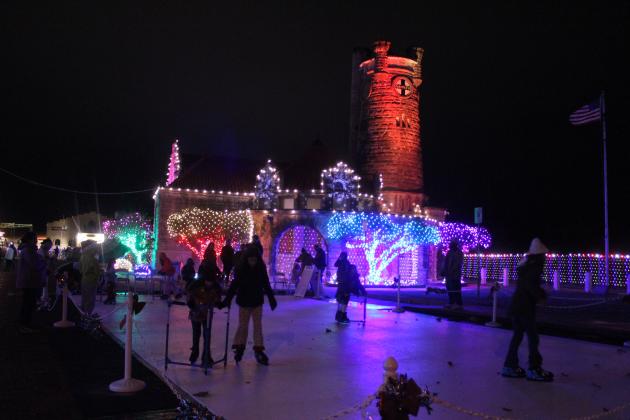 Several children and teens enjoy the ice-skating rink made of synthetic ice in front of the Santa Fe Depot in Shawnee during the Safe Events for Families "Winter Wonderland" on Nov. 28. Oklahoma Representative Dell Kerbs, with SEFF, said they had about 1,000 visitors to the free event in their opening weekend. Kerbs added that ice skates are available for those who need to borrow them. See full cutline below.
