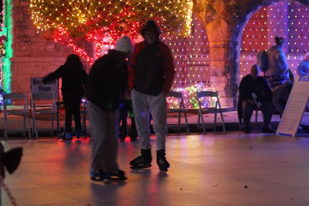 Daniela Mijares and Mason Daniels, both of Shawnee, try out the synthetic ice skating rink in front of the Santa Fe Depot during the Safe Events for Families "Winter Wonderland" on Nov. 28. Oklahoma Representative Dell Kerbs, with SEFF, said they had about 1,000 visitors to the free event in their opening weekend. Kerbs added that ice skates are available for those who need to borrow them. Extreme Inflatables brought the skating rink, three carnival rides and two inflatables.