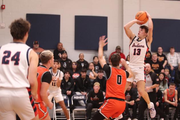 Asher's Pierce Aduddell tries for a tres in the Sat., Jan. 3, home game against Konawa. The Indians won 58-47.