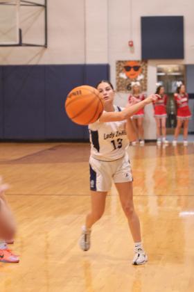 Asher's Amaya McFerran passes to Payton Madinger in the fourth quarter of the Jan. 16 home game against Vanoss. The Lady Indians lost 28-58.