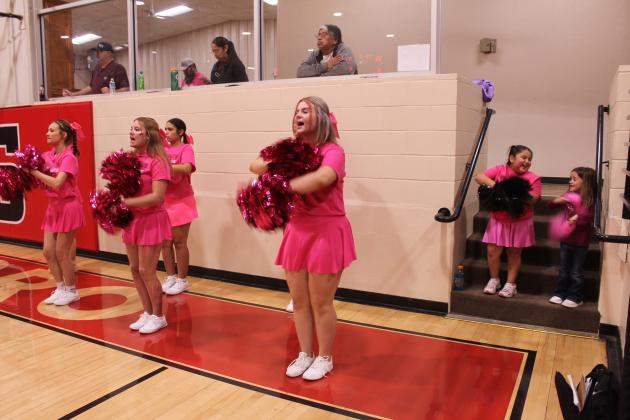 As the Earlsboro High School Cheerleaders root for the Wildcats, little cheerleaders Margaret Fields, 6, and Emma Dailey, 5, both of Earlsboro, have fun trying to copy them during the home Pink Out game on Jan. 6. Natasha Dunagan, Countywide &amp; Sun