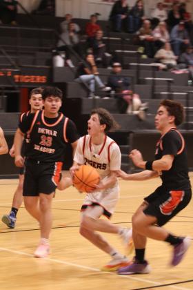 Maud senior Colt Abbott takes it to the hoop and prepares to shoot during the fourth quarter of the Jan. 16 home game with Dewar. The Tigers won 56-49. Earlier, the Lady Tigers lost 28-70.