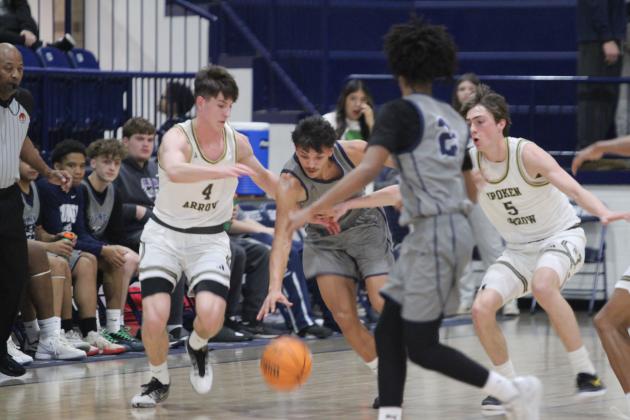 Shawnee junior Levi Baughman gets fouled on his way to the hoop during the game against Broken Arrow in the Shawnee Invitational on Jan. 22. The Wolves lost that game, 39-66, and on the previous day, they won against El Reno, 52-43.