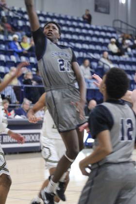 Shawnee sophomore Brendan Johnson sinks a layup and draws the foul during the Jan. 22. game against Broken Arrow in the Shawnee Invitational. The Wolves lost that game, 39-66, and on the previous day, they won against El Reno, 52-43.