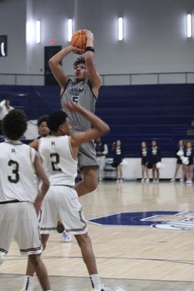 Shawnee sophomore Ian Samilton aims a jumper during the Jan. 22. game against Broken Arrow in the Shawnee Invitational. The Wolves lost that game, 39-66, and on the previous day, they won against El Reno, 52-43.