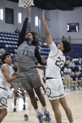 Shawnee senior Aidon Siqueiros drops in two points during the Jan. 22. game against Broken Arrow in the Shawnee Invitational. The Wolves lost that game, 39-66, and on the previous day, they won against El Reno, 52-43.