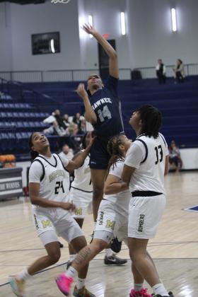 Shawnee junior JaNya Bruner tries for a basket in the Jan. 22 game against Midwest City during the Shawnee Invitational. The Lady Wolves lost this hard-fought game 50-54. The day before, they won with Harding Charter 55-19.