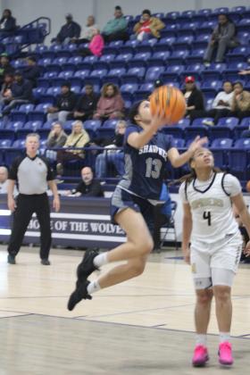 Shawnee freshman Eliana Shields sails toward the basket and sinks her shot in the Jan. 22 game against Midwest City. Natasha Dunagan, Countywide &amp; Sun