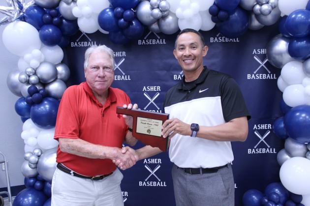 Asher Head Baseball Coach Elliott Alberson, right, presents Asher 1965 graduate Dwight Bowen with a Baseball Hall of Fame Award during his induction at the Second Annual Asher Baseball Hall of Fame &amp; Spring Season Kickoff Banquet on March 21.