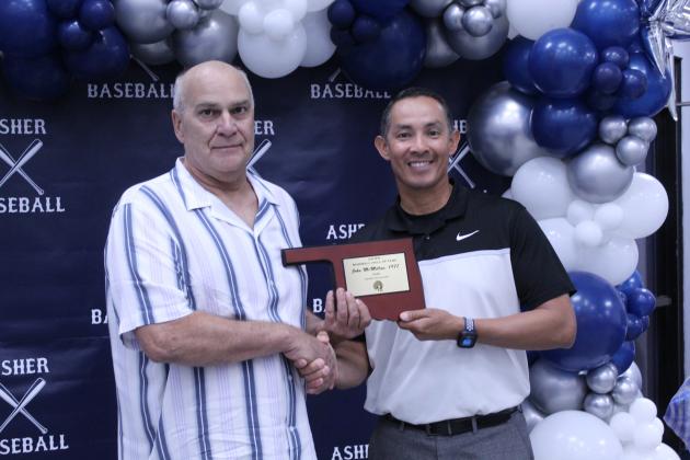 Asher Head Baseball Coach Elliott Alberson, right, presents Asher 1977 graduate John McMillan with a Baseball Hall of Fame Award during his induction at the Second Annual Asher Baseball Hall of Fame &amp; Spring Season Kickoff Banquet on March 21.