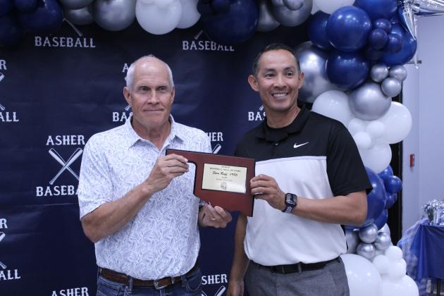 Asher Head Baseball Coach Elliott Alberson, right, presents Asher 1980 graduate Stan Ruff with a Baseball Hall of Fame Award during his induction at the Second Annual Asher Baseball Hall of Fame &amp; Spring Season Kickoff Banquet on March 21.