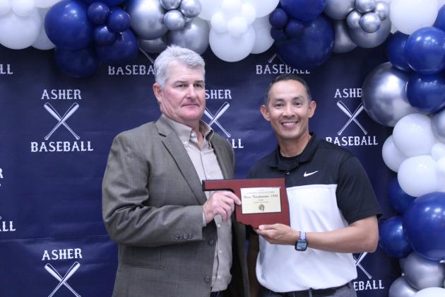 Asher Head Baseball Coach Elliott Alberson, right, presents Asher 1984 graduate and former coach Bruce Throckmorton with a Baseball Hall of Fame Award during his induction at the Second Annual Asher Baseball Hall of Fame &amp; Spring Season Kickoff Banquet on March 21.