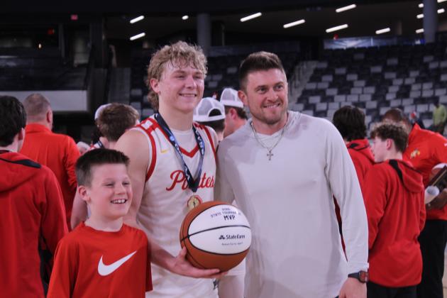 Dale senior Denton Forsythe receives the 2026 Class 2A State Tournament MVP game ball from Rotnei Clarke, a State Farm Insurance Agent and former Verdigris High School and University of Arkansas basketball player, following the state championship victory at the OG&amp;E Coliseum in OKC on March 14.