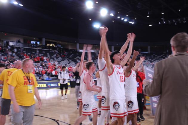 After winning their fifth straight state championship, the Dale Pirates, including junior Keiton Hill (#15), rally the crowd, before receiving an oversized commemorative bracket of the tournament on March 14 at the OG&amp;E Coliseum.
