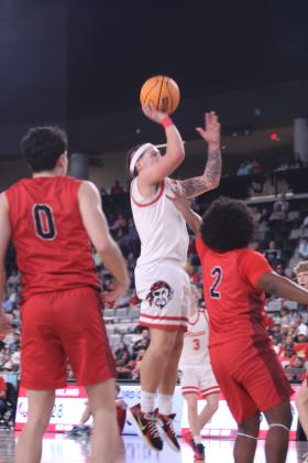 After an assist from fellow Dale senior Denton Forsythe, Wyatt Seeley puts another two points through the hoop during the third quarter of the Class 2A State Championship against Fairland, held at the OG&amp;E Coliseum in OKC on March 14. This is the fifth straight state championship win for the Pirates who conquered this game, 82-40; as well as the two previous games against Oklahoma Christian Academy, 80-57, and Vanoss, 75-35. They end their season with a record of 30-2.