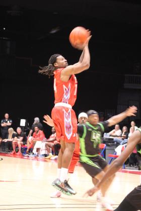 Potawatomi Fire Guard Jahmal McMurray tries for a trey in the first quarter of the March 20 home game against the Little Rock Lightning.