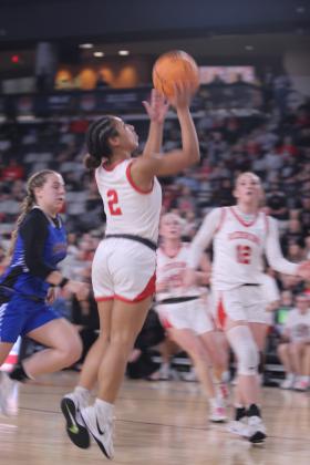 McLoud junior Claire Mapira aims and sinks her shot during the Class 4A State Quarterfinal game against Harrah, at the OG&amp;E Coliseum in OKC on March 10. The Lady Redskins won, 44-30, and advance to the Semifinals today (March 12) at 6 pm in Yukon. If they win, they will move on to the Finals on Friday, March 13, at 7:45 pm, back at the Coliseum. Click on the camera banner ad below to see all the photos from the game!