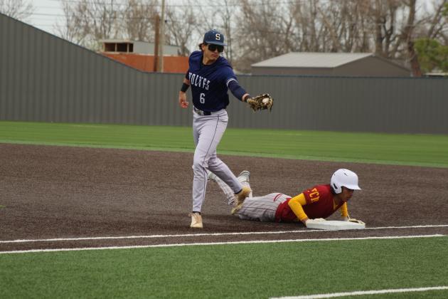 Shawnee senior Corbin Wood makes the catch just after the Putnam City North runner dives back to first in the home game on March 7 at their newly-rebuilt facility, complete with turf.