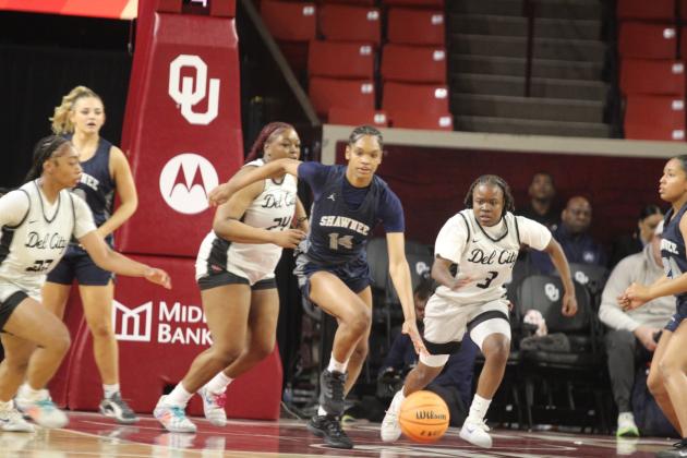 With a few Lady Eagles on her trail, Lady Wolf junior JaNya Bruner grabs the rebound and runs for the basket during the Class 5A State Quarterfinal game against Del City, held at the Lloyd Noble Center in Norman on March 12.