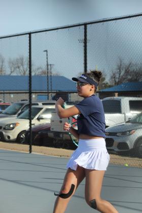 Shawnee sophomore December Nanaeto works on her back-hand during the Tennis Scrimmage against Tecumseh at Shawnee's newly completed facility on Feb. 24.