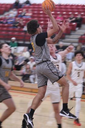 Tecumseh senior Jekhi Owens takes it to the hoop and adds two points in the Class 4A Regional Consolation Bracket game against Madill, held at McLoud on Feb. 26. They won that game, 66-57, and the next game with Byng, 73-69, before falling to McLoud, 50-59. The Savages end their season with a record of 15-13. Photos by Natasha Dunagan, Countywide &amp; Sun