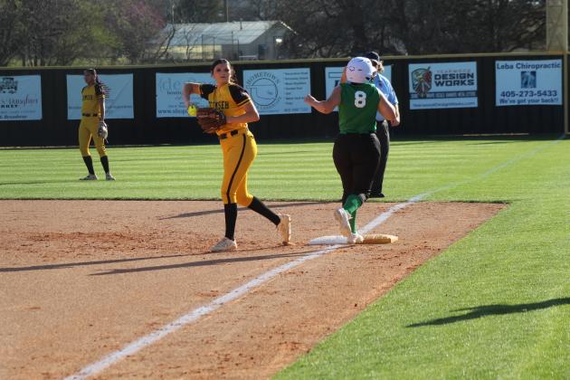 After stepping on first, Tecumseh junior Jacee Townsend throws to the pitcher after a Seminole runner reaches the base during the slow pitch softball season opening game on March 9.
