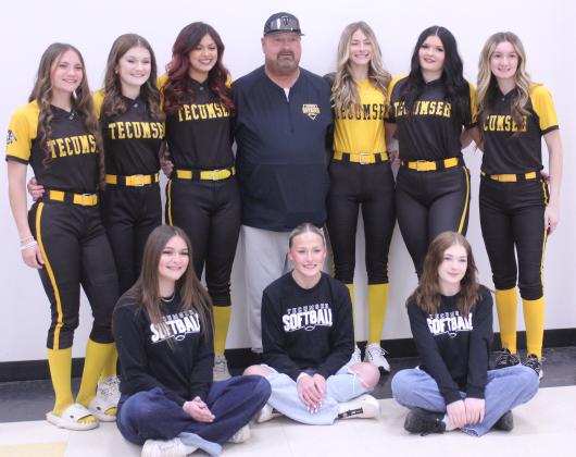 Juniors on the Tecumseh High School Slow Pitch Softball Team pose with Head Coach Perry Wilson during their first Media Day on Feb. 7. They are, from left, Madison Gray, Josie Walker, Genesis Fixico, Wilson, Haley Mansell, Jacee Townsend, Jaylie Anderson, managers seated, Abbi Jordan, Rylee Chaffin and Chloe Burks. The Lady Savages will have their first home game against Seminole on March 9.