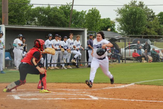Asher's Noah Franco races the ball to home plate, as Macomb catcher Radlee Blaine waits for the catch, during the Class B District Tournament at Asher on April 22. With the win for both games, the Asher Indians will host Regionals today (April 30) and play Carney at 11 am, according to ossaa.com.