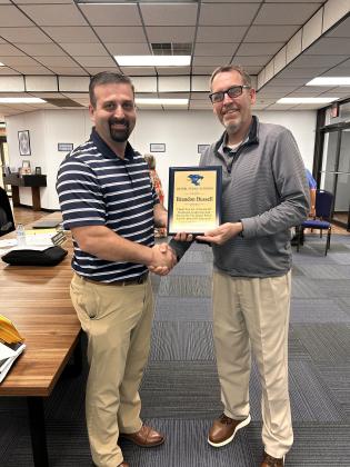 Brandon Bussell (pictured left) is presented a plaque by Superintendent Dr. Matt Posey (right) for his 10 years of service on the Bethel School Board. Suzie Campbell, Countywide &amp; Sun