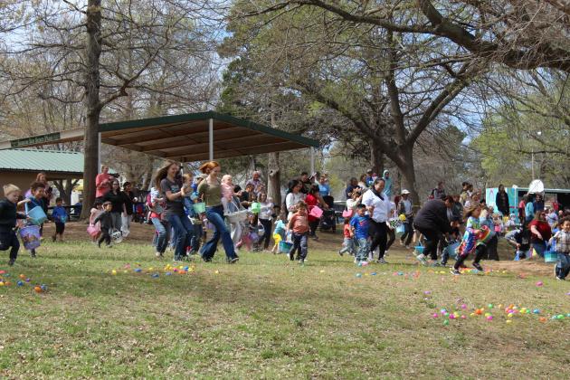 Parents and toddlers run down a hill at Boy Scout Park after the signal was given to start the egg hunt on March 28. The Community Renewal Easter Block Party featured more than 30,000 filled plastic eggs, including those left over from last year when the event was rained out twice, said C.R. Executive Director Brandon Dyer. After being started by local churches, Dyer said one of their members continued the event, which is in its sixth year.