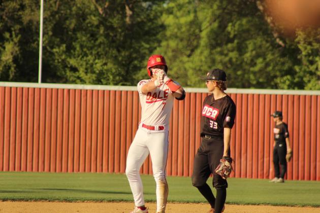 Dale senior Denton Forsythe signals to his team after hitting a double and sliding into second in the seventh inning of the April 6 home game against Oklahoma Christian Academy. The Pirates won, 8-0.