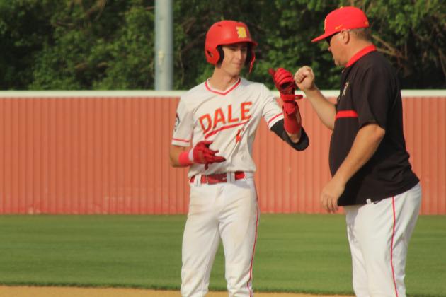 Dale junior Chase Harris gets a fist bump from Head Coach Cody Merrell after landing on first base at the April 17 home game against Jones. The Pirates won 4-2.