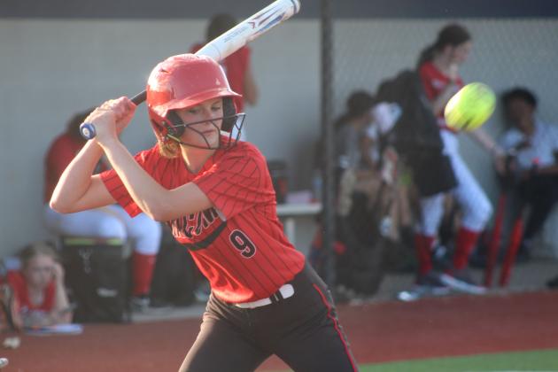 Macomb freshman Brookelynn Johnson passes on a ball before walking during the April 2 game.