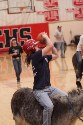 Firefighter Lucky Bohannon aims for the hoop during the Third Annual Earlsboro Donkey Basketball fundraiser on April 4 at the EHS Gym. Sponsored by the Earlsboro Fire Department and Police Department, the event raised $5,801 this year, which goes toward things like vehicle maintenance, fuel, equipment upgrades and firefighter gear, according to Police Chief Christopher Bayless and Firefighter Beau Dailey.