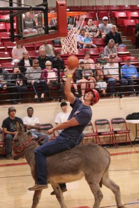 Earlsboro firefighter Caleb Inman makes a basket during the Third Annual Earlsboro Donkey Basketball fundraiser on April 4 at the EHS Gym.