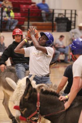 Tre Williams, with the Booking Broncos, puts up a shot during the Third Annual Earlsboro Donkey Basketball fundraiser on April 4 at the EHS Gym.