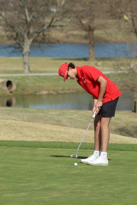North Rock Creek's Parker Ramsey putts on the ninth hole.