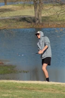 Tecumseh senior Landyn Seaton chips it toward the ninth hole.
