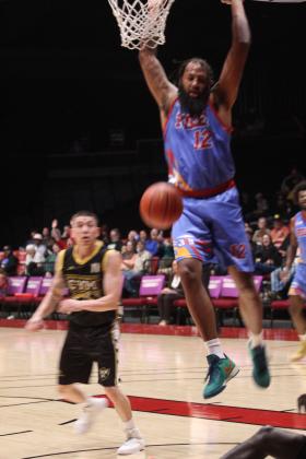 Potawatomi Fire Center Johnny McCants picks up the rebound and makes a slam dunk in the fourth quarter of the March 28 home game. The Fire continued their winning streak with a score of 145-105.