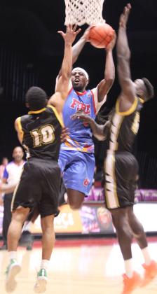 Potawatomi Fire Forward KD Moore fights his way through two CYM Leopards to get to the basket in the third quarter of the March 28 home game. The Fire continued their winning streak with a score of 145-105. Photos by Natasha Dunagan, Countywide &amp; Sun