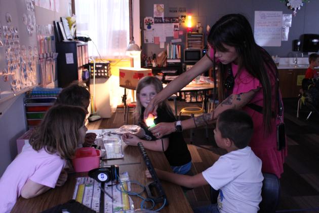 First-grade teacher Serena Neely, at Will Rogers Elementary in Shawnee, "candles" a duck egg to show her students how the duckling is growing - or if it has stopped - on April 16. Neely was the District Teacher of the Year for 2024-'25, and she is a top-10 finalist for State Teacher of the Year.