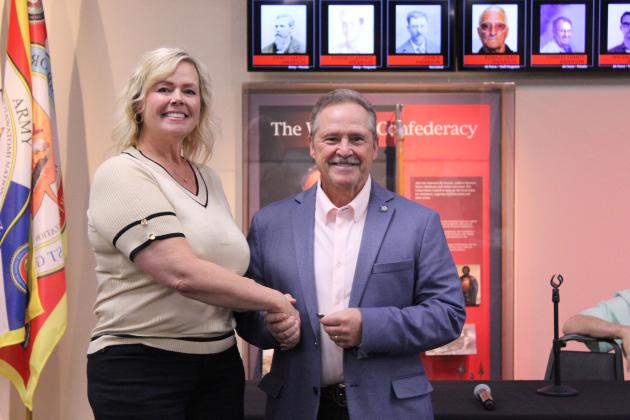 Crystal Romanyszyn, a member of Select Oklahoma and Shawnee Forward president, presents a challenge coin from Select Oklahoma to State Representative Danny Sterling. Sterling earned the coin for his record of voting for economic development initiatives. The presentation happened at the Tecumseh Chamber of Commerce Legislative Luncheon, held at the CPN Cultural Heritage Center on April 10.